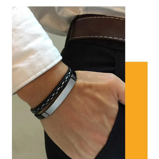 Man wearing the Crest stitched leather bracelet with silver ID plate