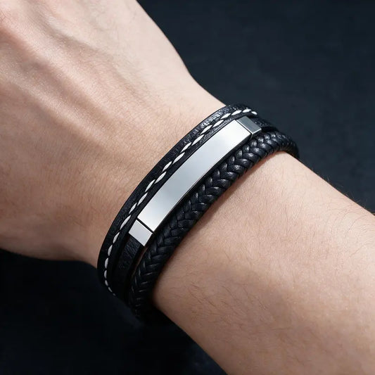 Marlin leather bracelet with silver ID plate, worn on a man's wrist.