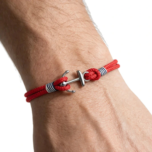 Red double-strand rope bracelet with an anchor-shaped stainless steel clasp, worn on wrist
