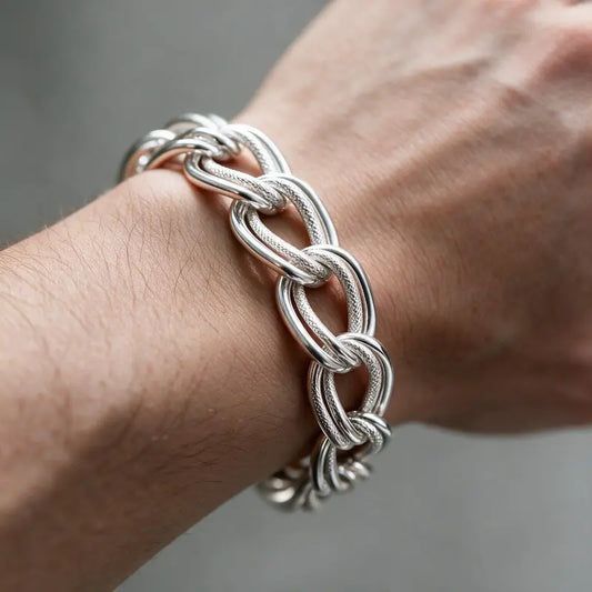 Chunky silver interlocking link chain bracelet worn on the wrist