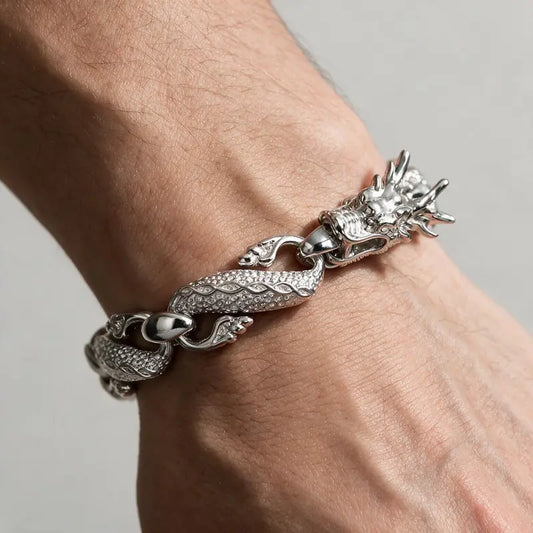Silver dragon-link chain bracelet worn on the wrist