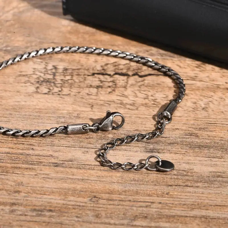Close-up of silver stainless steel slim snake link bracelet clasp