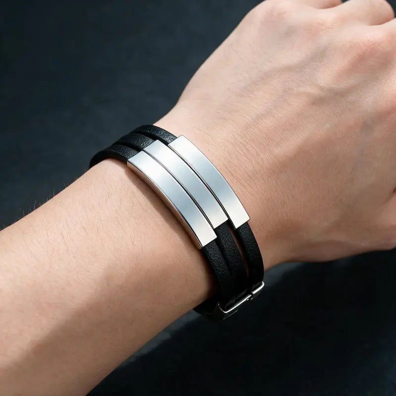Duet leather bracelet with silver ID plates, worn on a man's wrist.