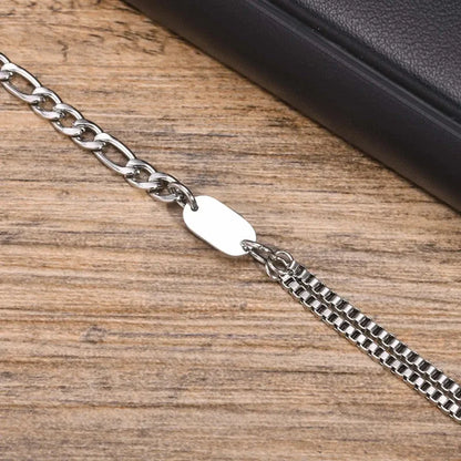 Insignia initial chain bracelet laid flat on a wooden surface