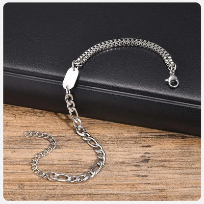 Insignia chain bracelet laid out on a dark leather surface, clasp open