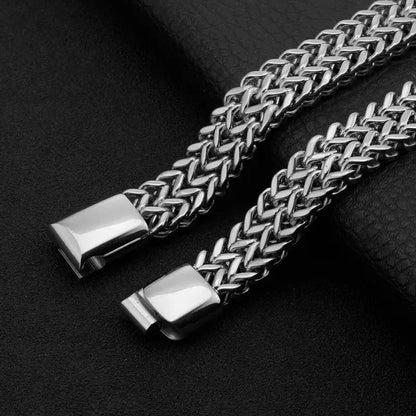 Close-up of the magnetic clasp on the Ironclad Cuban Chain Bracelet, shown open against a black leather background.