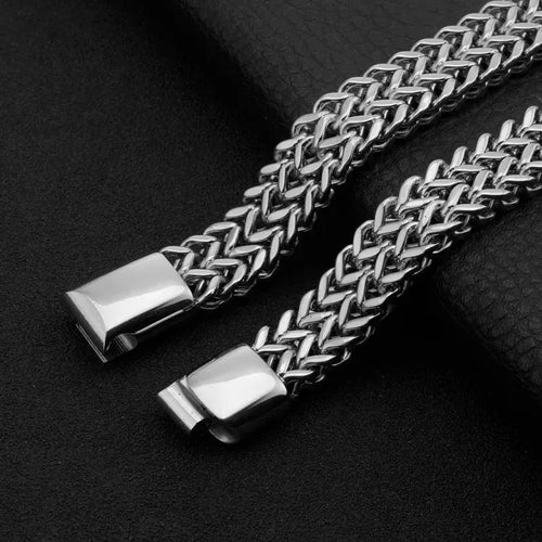 Close-up of the magnetic clasp on the Ironclad Cuban Chain Bracelet, shown open against a black leather background.