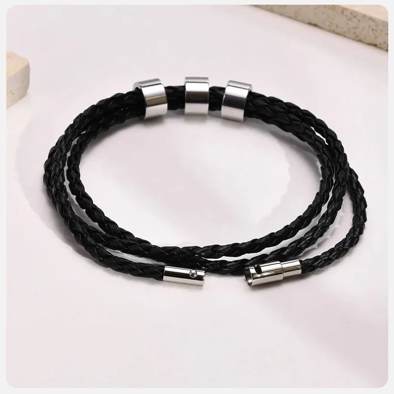 Lineage bracelet coiled, showing the braided leather band detail