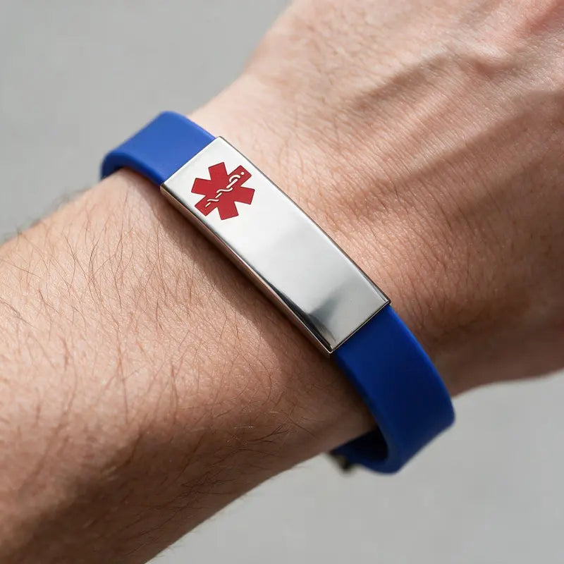 Sentry blue silicone medical alert bracelet with red caduceus symbol, worn on a man's wrist.