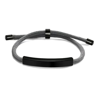 Voyager adjustable cord bracelet in grey with black-tone nameplate