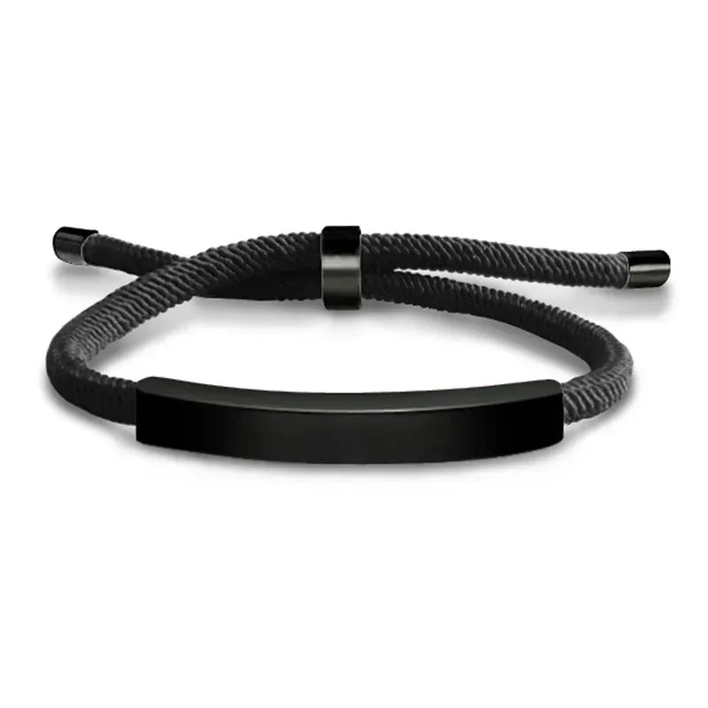 Black woven cord bracelet with a black-finish nameplate and matching black adjustable slider clasp, on a white background.