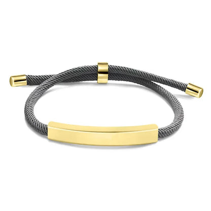 Voyager adjustable cord bracelet in grey with gold-tone nameplate