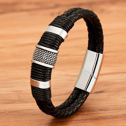 Close-up of a black woven leather rope bracelet with steel rondelle beads worn on the wrist