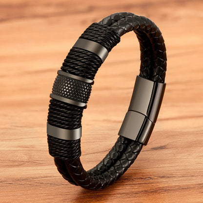 Black woven leather rope bracelet with a magnetic clasp, detail shot on a leather surface