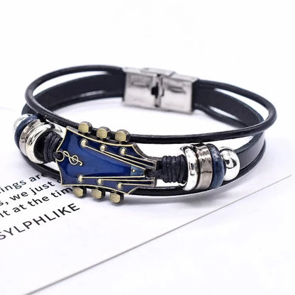 Black leather bracelet with a blue enamel guitar headstock charm, on a white background