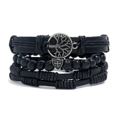 Black leather layered bracelet stack with a tree of life charm and a small cross shield charm, black wood beads, on a white background.