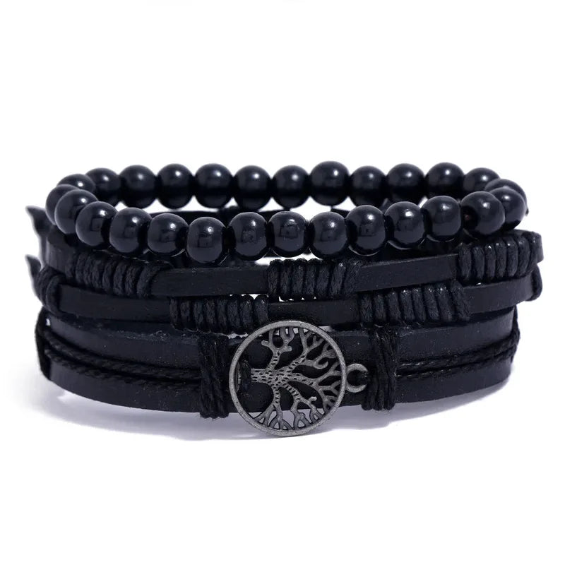 Black leather layered bracelet stack with a tree of life charm and large black round beads, on a white background.