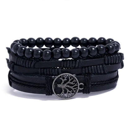 Black leather layered bracelet stack with a tree of life charm and large black round beads, on a white background.