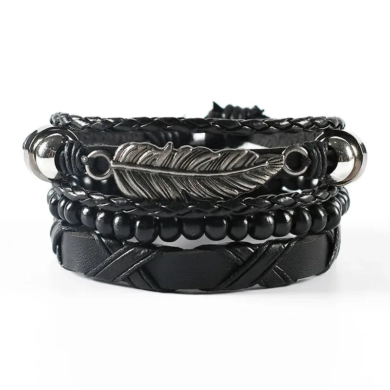 Black leather layered bracelet stack with a silver feather charm, wood beads, and silver ball ends, on a white background.