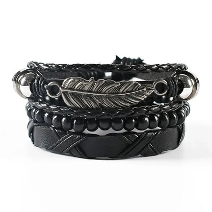 Black leather layered bracelet stack with a silver feather charm, wood beads, and silver ball ends, on a white background.