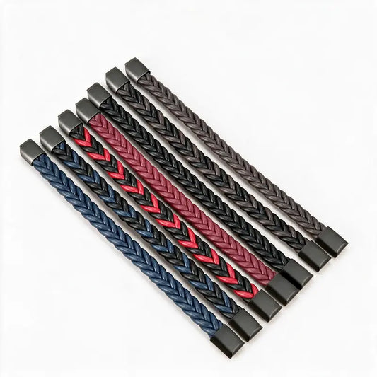 Seven leather herringbone braid bracelets in black, blue, red, and brown colorways, on a white background.