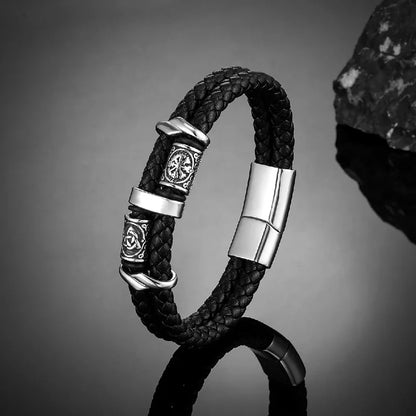 Black braided leather bracelet with silver-tone engraved Norse rune beads and a magnetic clasp
