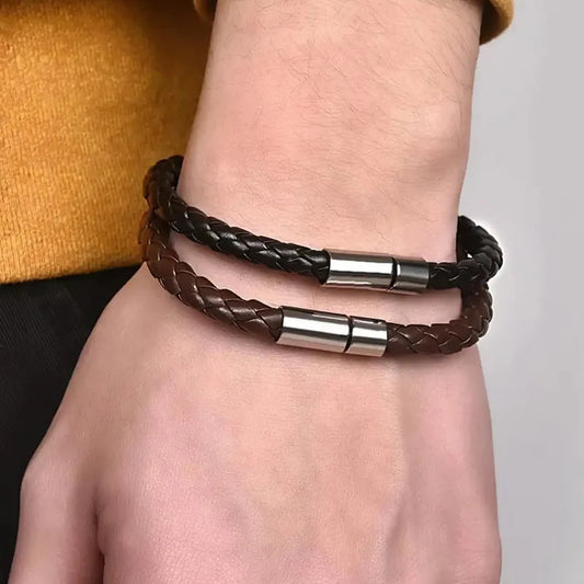 Black and brown braided leather bracelets worn together on a man's wrist