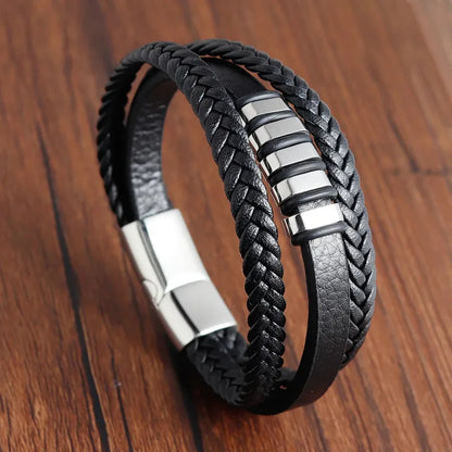 Multi-strand leather bracelet with a stack of silver metal rings, on a white background