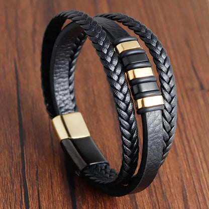 Multi-strand brown leather bracelet with a gold metal bar and gold ring discs, on a white background