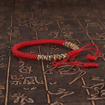Close-up of the King Kong knot on a red braided cord bracelet