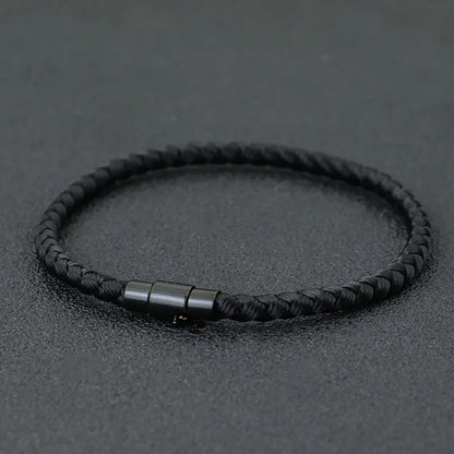 Black braided cord bracelet with a matching black stainless steel barrel clasp