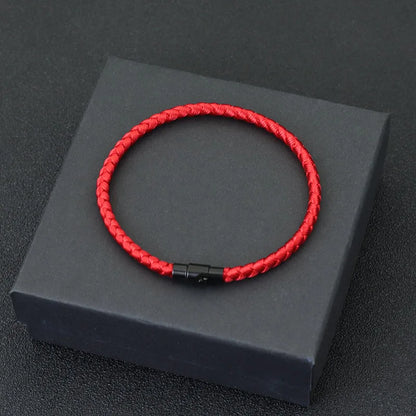 Red braided cord bracelet displayed in a gift box