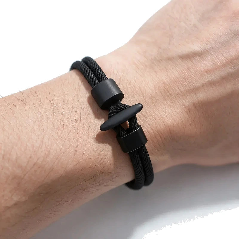 Black double-strand Milan mesh rope bracelet with a black T-bar toggle clasp, worn on wrist