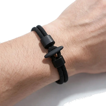 Black double-strand Milan mesh rope bracelet with a black T-bar toggle clasp, worn on wrist