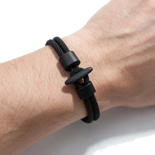 Black double-strand Milan mesh rope bracelet with a black T-bar toggle clasp, worn on wrist