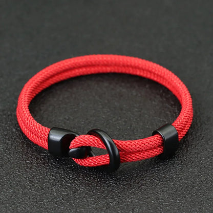 Red nylon rope bracelet double-wrapped around the wrist with a black alloy hook clasp