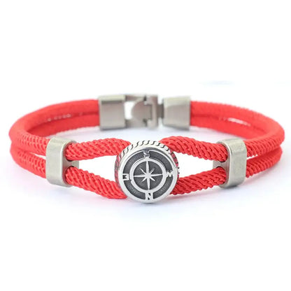 Red double-strand rope bracelet with an antique silver-tone compass charm