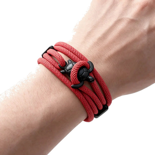 Reef Marine Charm Bracelet, red rope with black sea turtle charm, worn on wrist