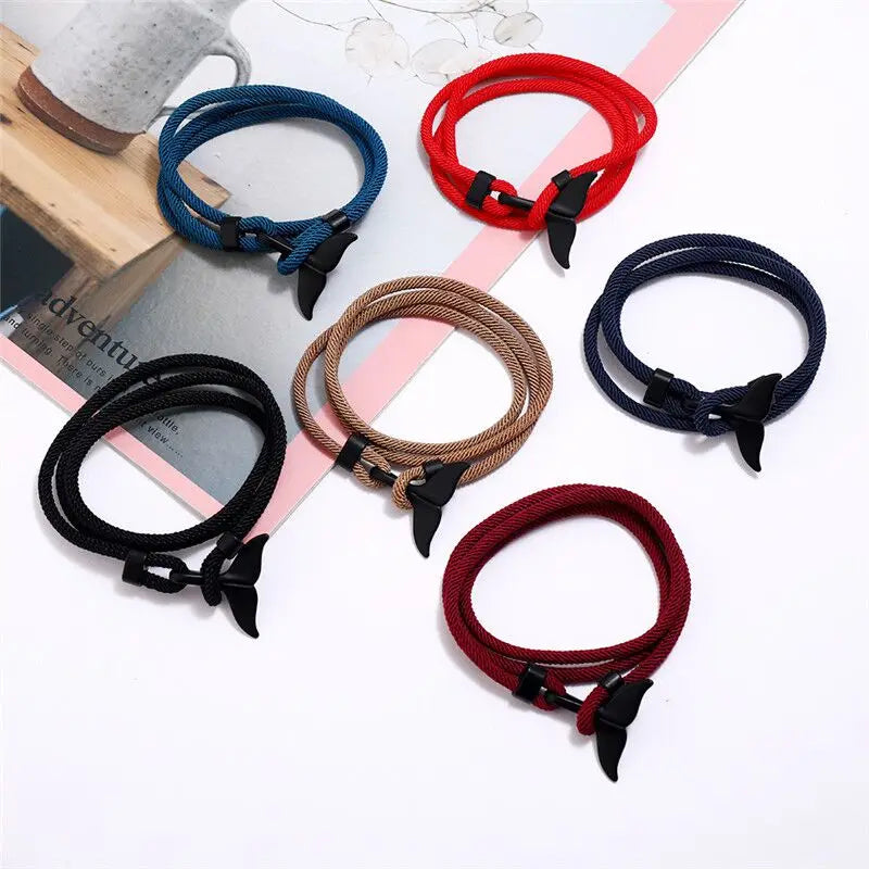 Whale tail charm rope bracelets shown together in six cord colors: blue, red, black, khaki, navy and wine