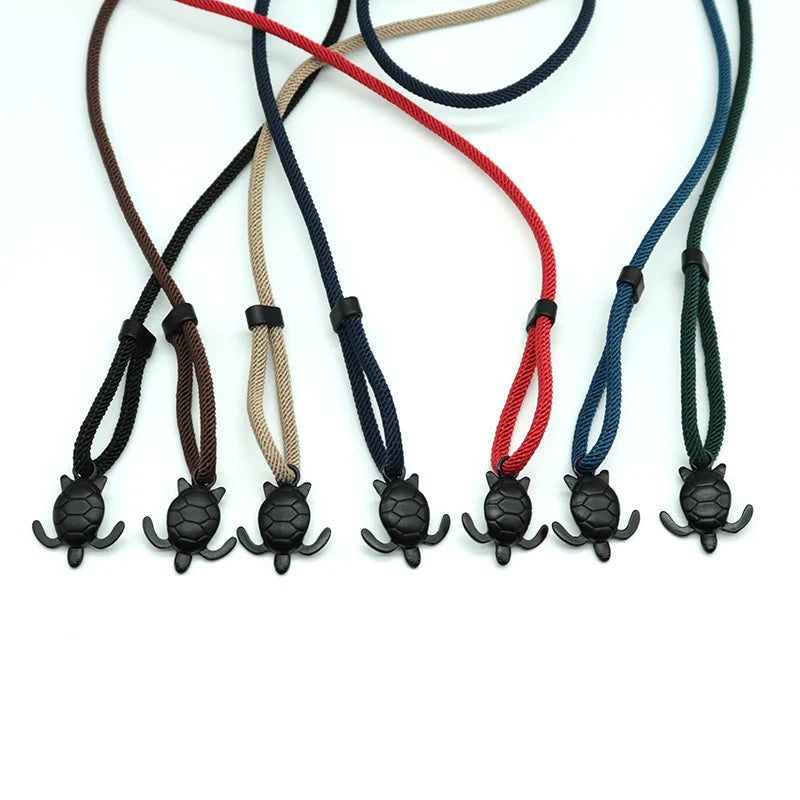 Sea turtle charm rope bracelets shown together in seven cord colors