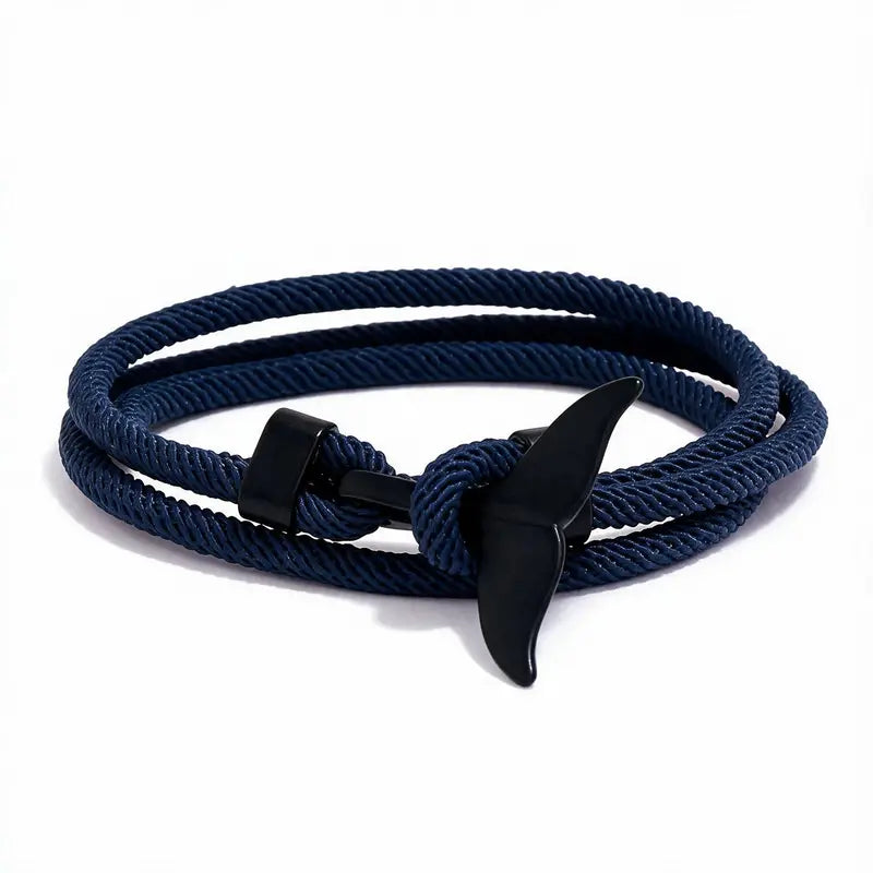 Whale tail charm in black finish on a dark blue rope bracelet