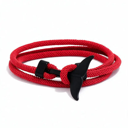 Whale tail charm in black finish on a red rope bracelet