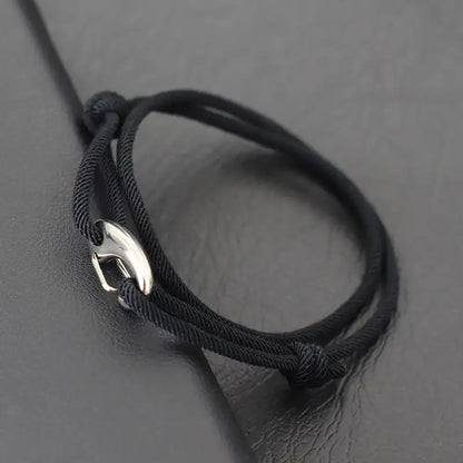 Black nylon rope bracelet double-wrapped with a curved metal hook clasp