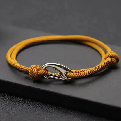 Dark yellow nylon rope bracelet double-wrapped with a curved metal hook clasp