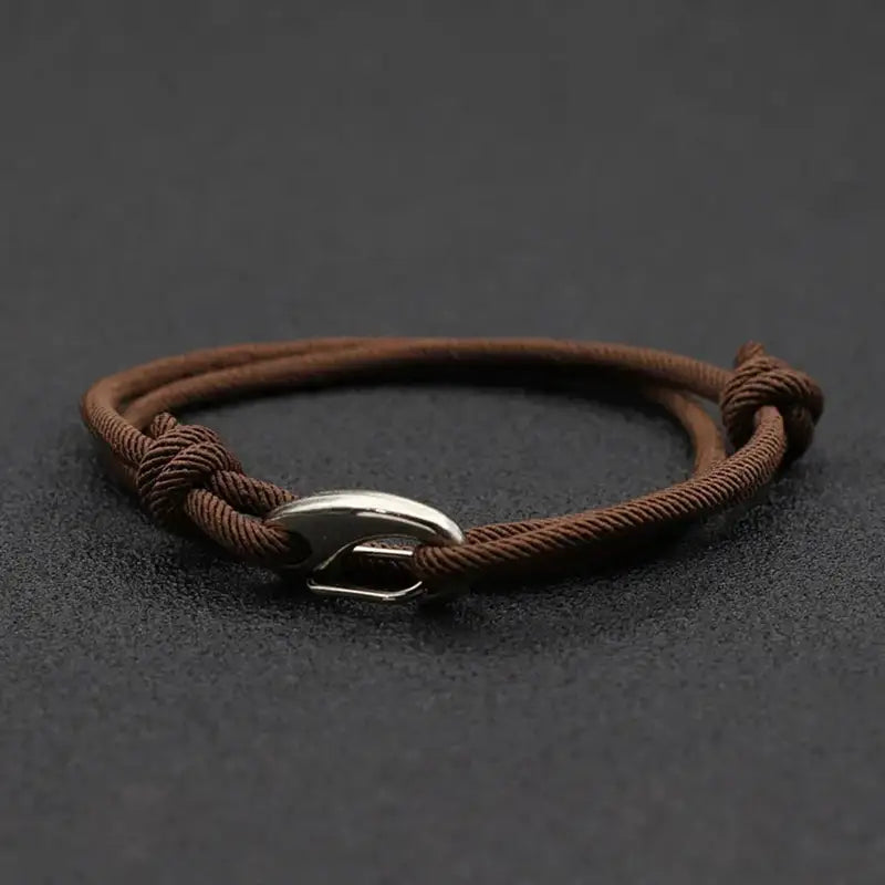 Brown nylon rope bracelet double-wrapped with a curved metal hook clasp