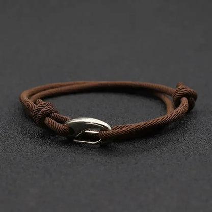 Brown nylon rope bracelet double-wrapped with a curved metal hook clasp