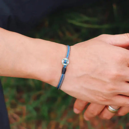Blue two-tone cord bracelet worn on the wrist