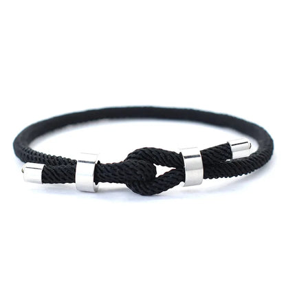 Black nylon cord bracelet with stainless steel end caps and a sliding knot