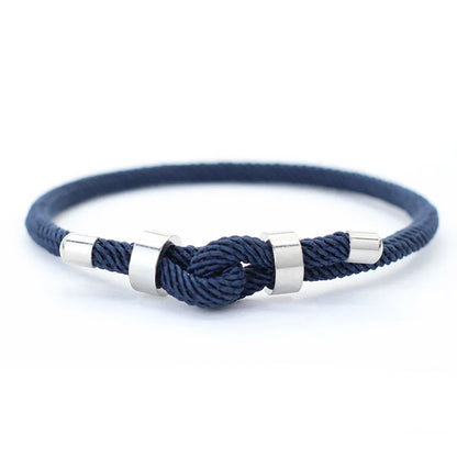 Navy nylon cord bracelet with stainless steel end caps and a sliding knot