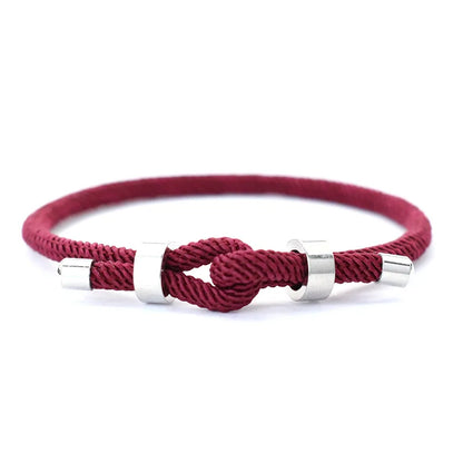 Wine-colored nylon cord bracelet with stainless steel end caps and a sliding knot